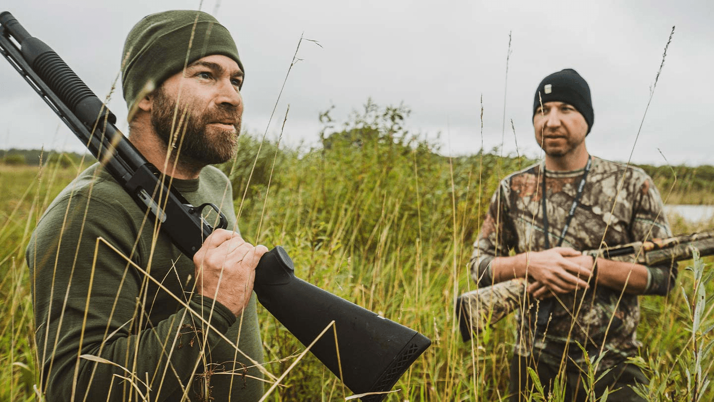two men hunting while wearing minus33 merino wool midweight crew long sleeve base layers and beanies