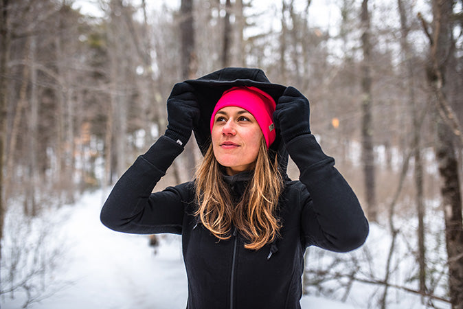 woman winter hiking wearing kodiak fleece expedition sweatshirt hoodie