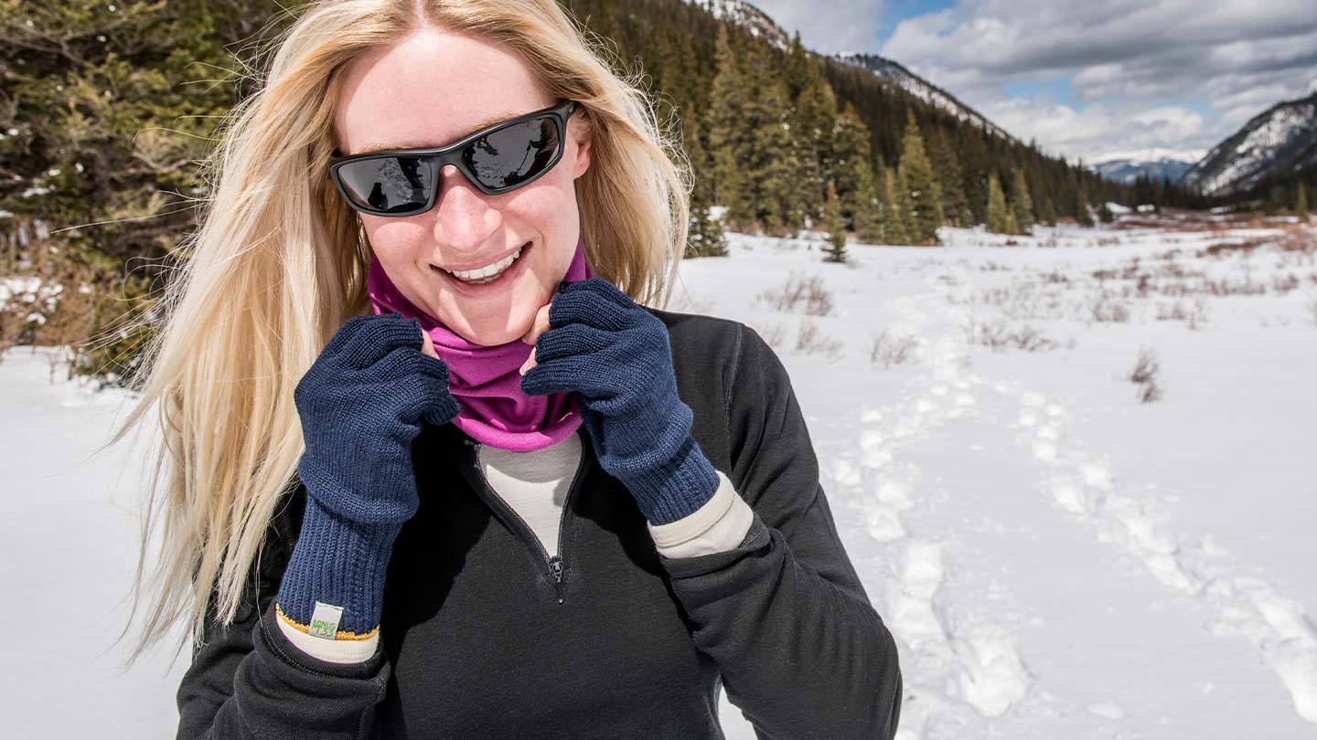 women snowshoeing wearing minus33 merino wool midweight base layers, gloves, and neck gaiters