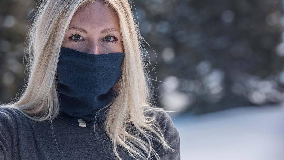 closeup of woman in snow wearing minus33 merino wool midweight neck gaiter
