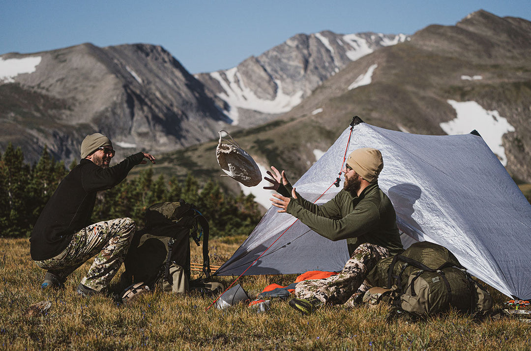 two men camping wearing merino wool hunting layers
