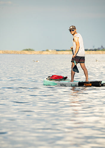 man paddle boarding wearing sleevless wool tank