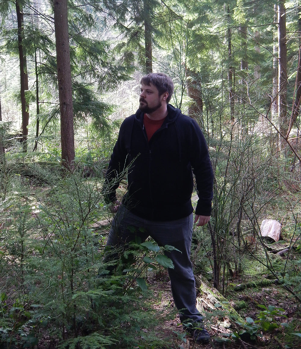 minus 33 merino wool clothing, Gear Junkie test the Kodiak Expedition Hoody, man in woods.