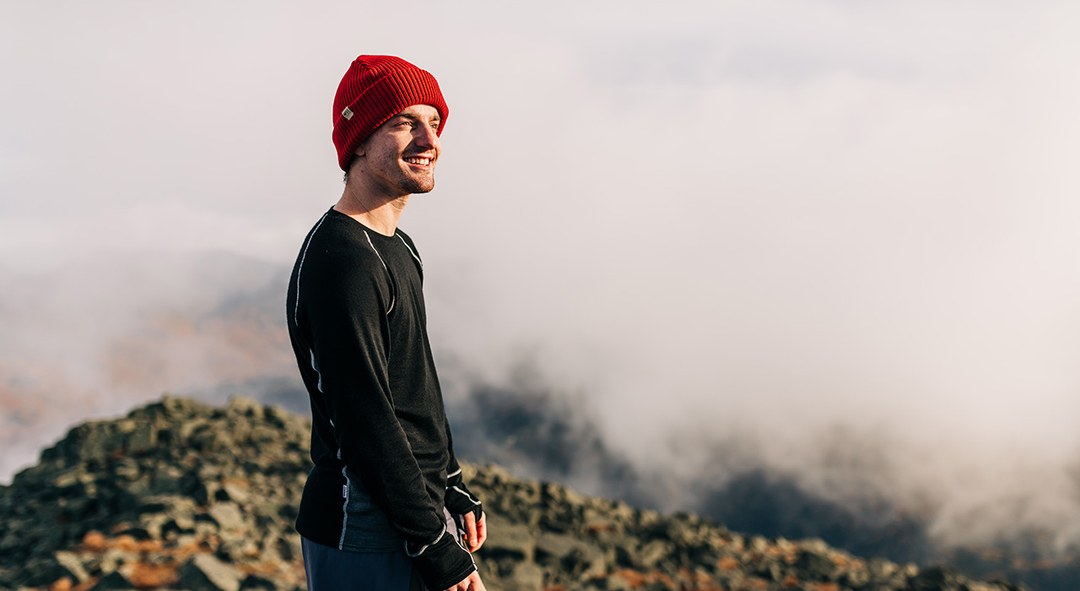 man hiking wearing a beanie and long-sleeved shirt