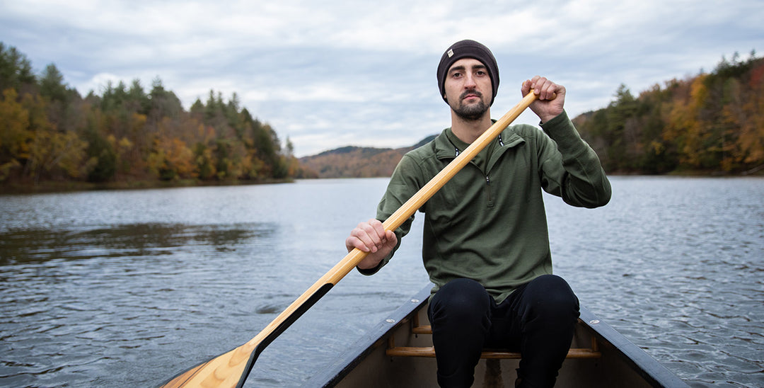 man canoeing wearing beanie and midweight quarter zip 