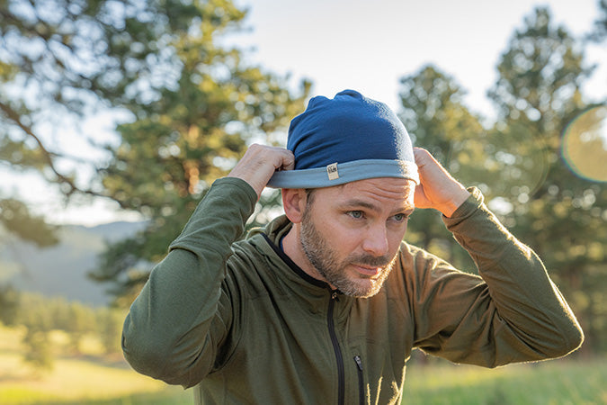 man wearing micro weight reversible shade beanie in color navy blue slate blue
