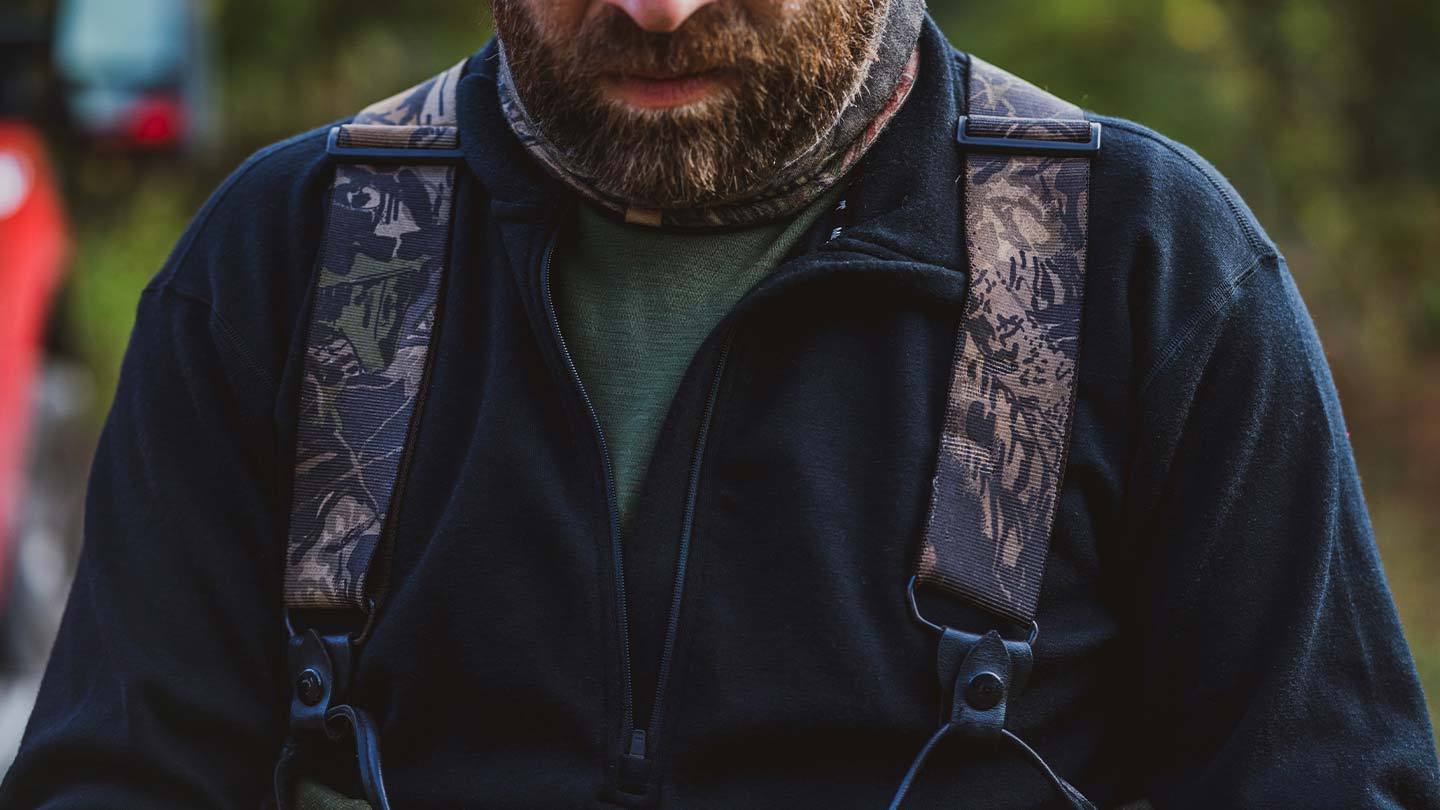 closeup of man wearing minus33 merino wool expedition 1/4 zip mid layer shirt