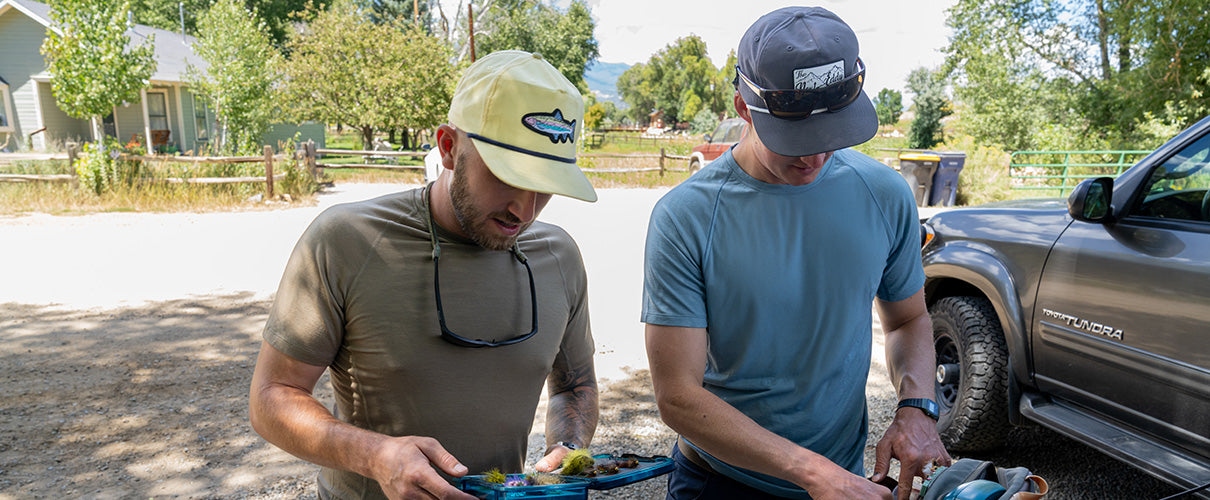 two men getting ready to go fishing wearing micro weight raglan woolverino tshirts