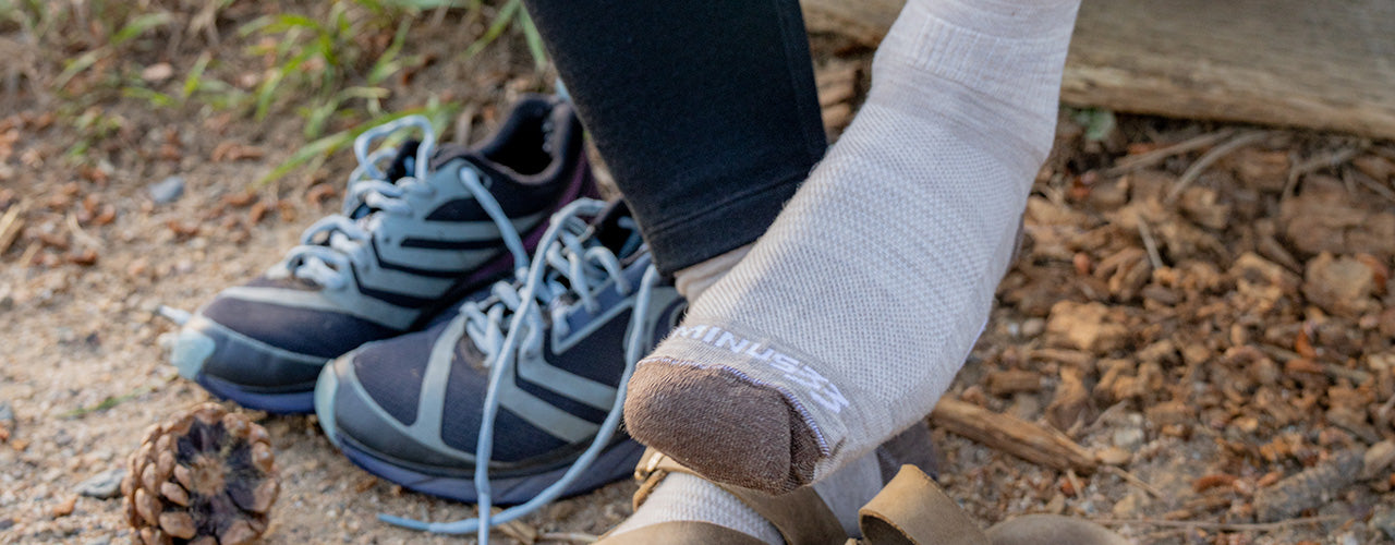 woman putting on nh usa made sock to go running