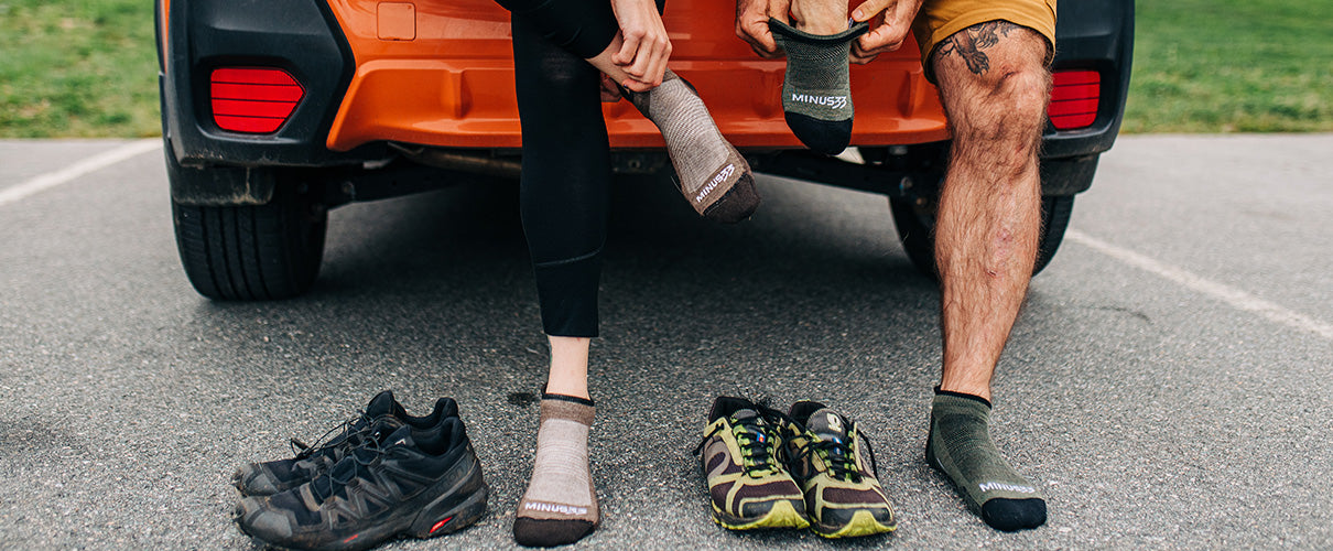 No show running socks. Male and female putting on socks about to go for a run sitting in the trunk of a car