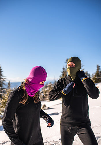 people hiking in the winter wearing midweight thermal layers and midweight balaclavas that are 100% merino wool