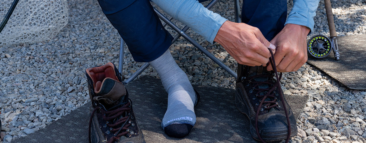 man tying boots wearing mountain heritage merino wool nh usa made socks