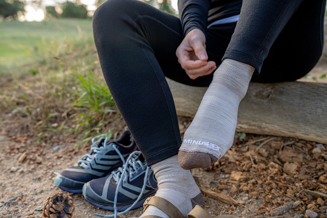 woman putting on sneakers wearing mountain heritage usa made socks and midweight woolverino leggings